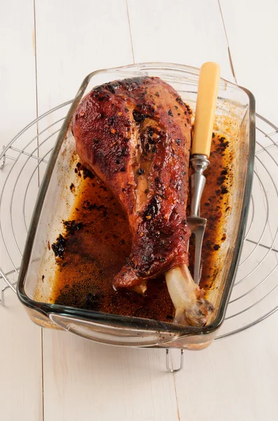 Grilled turkey leg in a fire proof glass bowl — Stock Photo, Image