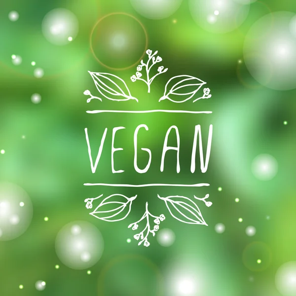 Label produk vegan pada latar belakang yang kabur - Stok Vektor