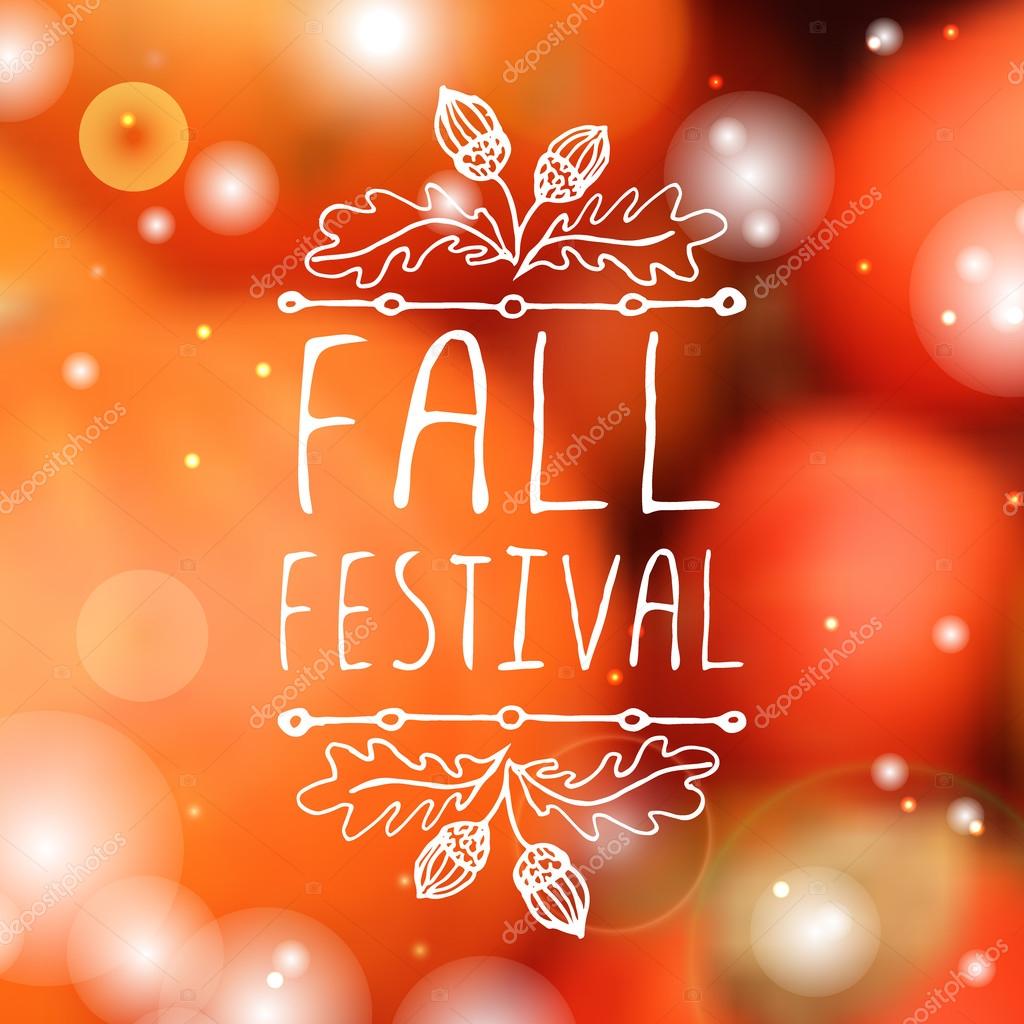 Fall festival. Hand-sketched typographic element with acorns on blurred background