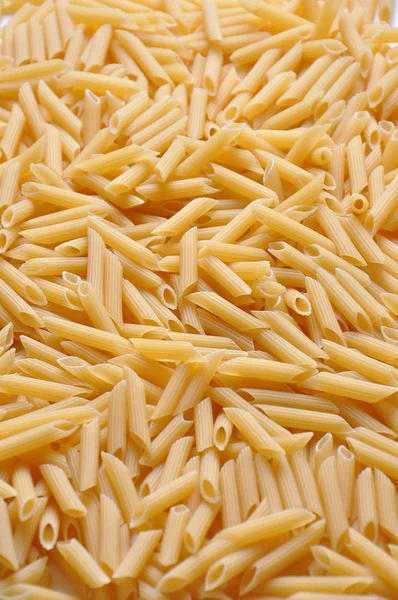 Close up of yellow raw italian pasta — Stock Photo, Image