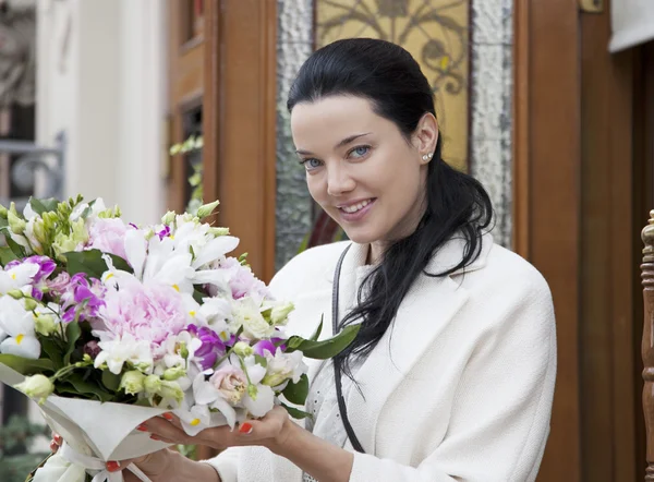 Young woman with floral bouquet