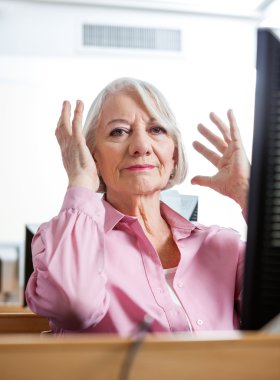 Portrait Of Stressed Senior Woman In Computer Class clipart