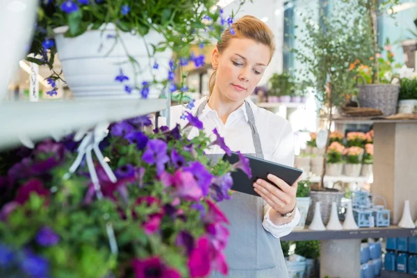 Frau nutzt digitales Tablet im Blumenladen — Stockfoto