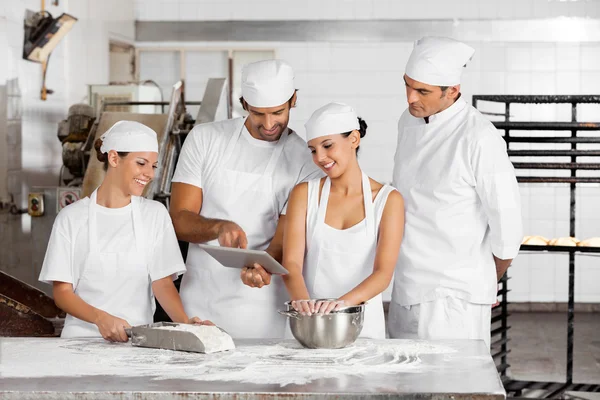 Bakers Using Digital Tablet Together At Table — Stock Photo, Image
