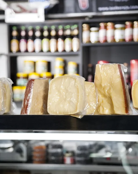 Pedaços de queijo exibidos na loja — Fotografia de Stock