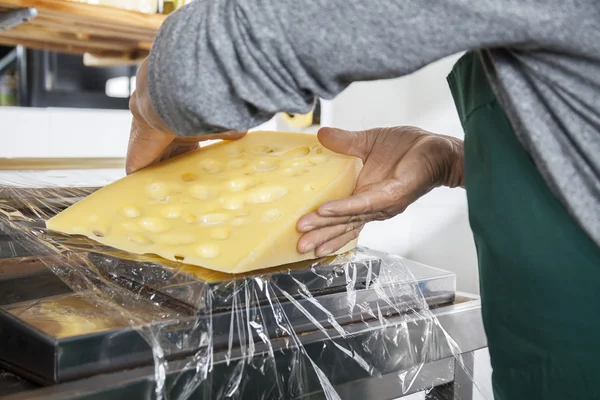 Midsection Of Senior Salesman Packing Cheese — Stock Photo, Image