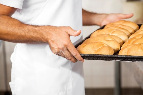 Midsection Of Male Baker Carrying Breads In Baking Tray — Stock Photo, Image