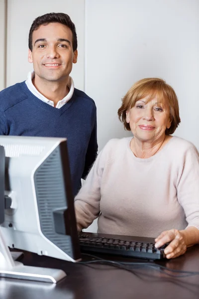 Happy Tutor And Senior Woman In Computer Lab — Stock Photo, Image