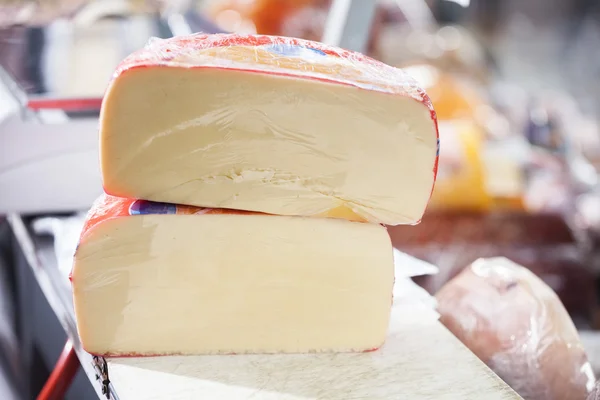 Pedaços de queijo exibidos no mercado — Fotografia de Stock