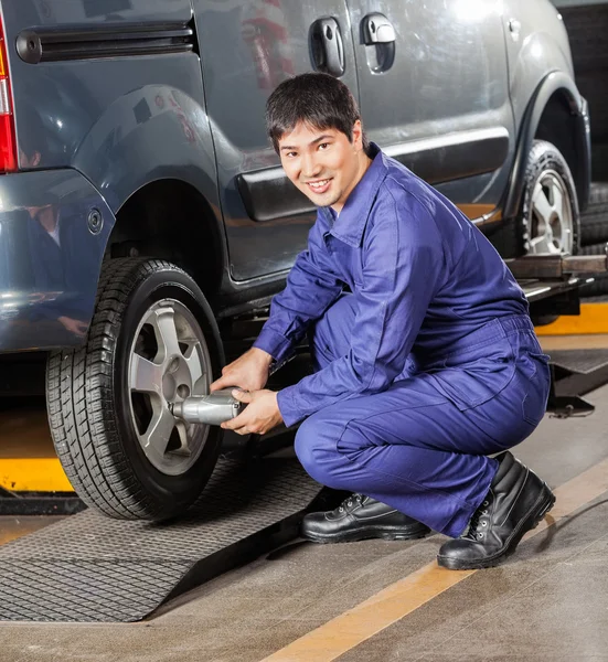 Mechaniker befestigt Autoreifen mit Luftschlüssel — Stockfoto