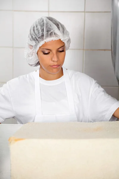 Padeiro feminino olhando para o pão fresco — Fotografia de Stock