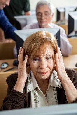 Stressed Senior Woman In Computer Class clipart