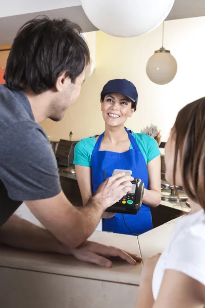 Man Making NFC Payment While Standing With Daughter And Worker — Zdjęcie stockowe