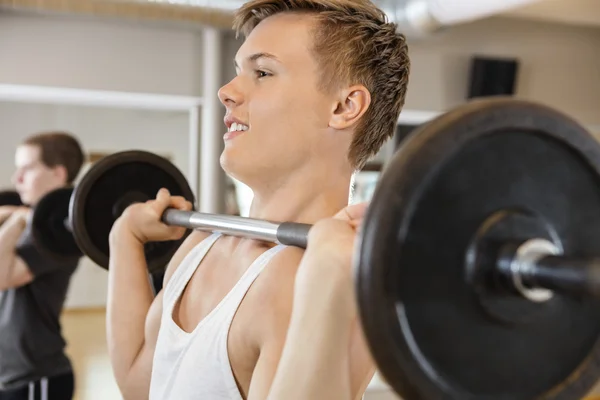Handsome Man Lifting Barbell In Gym — 图库照片