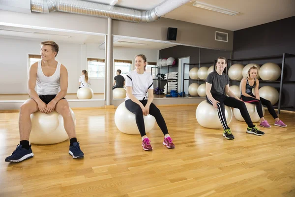 Spor salonunda egzersiz topu oturan arkadaşlar — Stok fotoğraf
