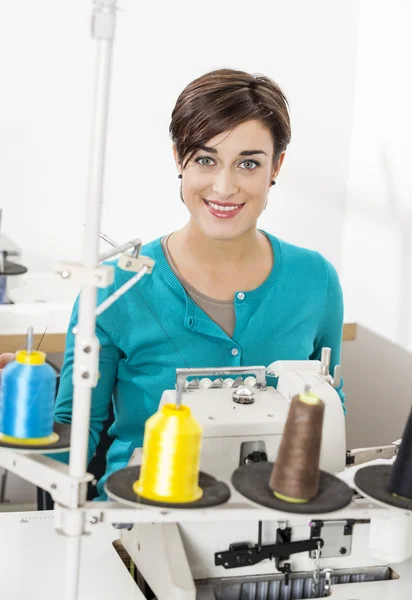 Happy Tailor Sitting At Workbench In Sewing Factory — Stock Photo, Image