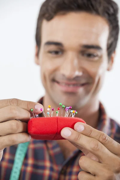 Tailor Putting Pin In Cushion — Stock Photo, Image