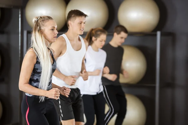 Mujer haciendo ejercicio con amigos en el gimnasio — Foto de Stock