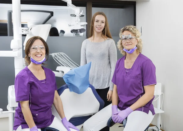 Zahnärztinnen und Patientin lächeln in Klinik — Stockfoto