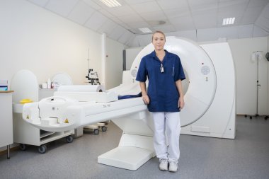 Portrait Of Radiologist Standing By Magnetic Resonance Imaging M clipart