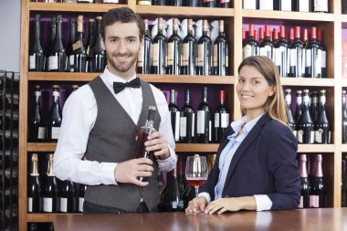 Portrait Of Customer And Bartender With Red Wine At Counter clipart