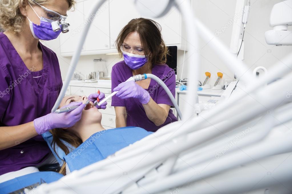 Dentists Working On Patients Teeth