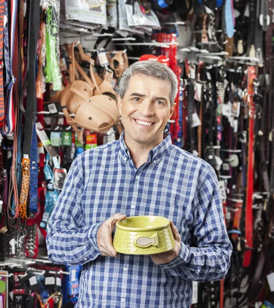 Happy Customer Holding Food Bowl at Pet Store — стоковое фото