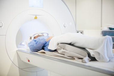 Patient Wearing Head Coil During MRI Scan In Hospital clipart