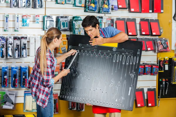 Customer And Salesman Checking Wrench Size Using Board — Stockfoto