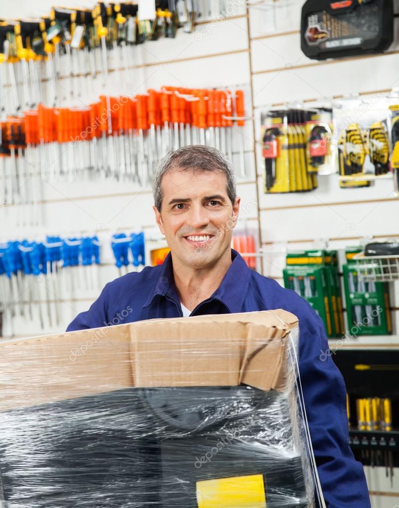 Worker With Wrapped Package In Hardware Shop