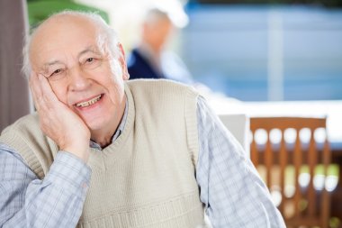 Portrait Of Smiling Senior Man At Nursing Home