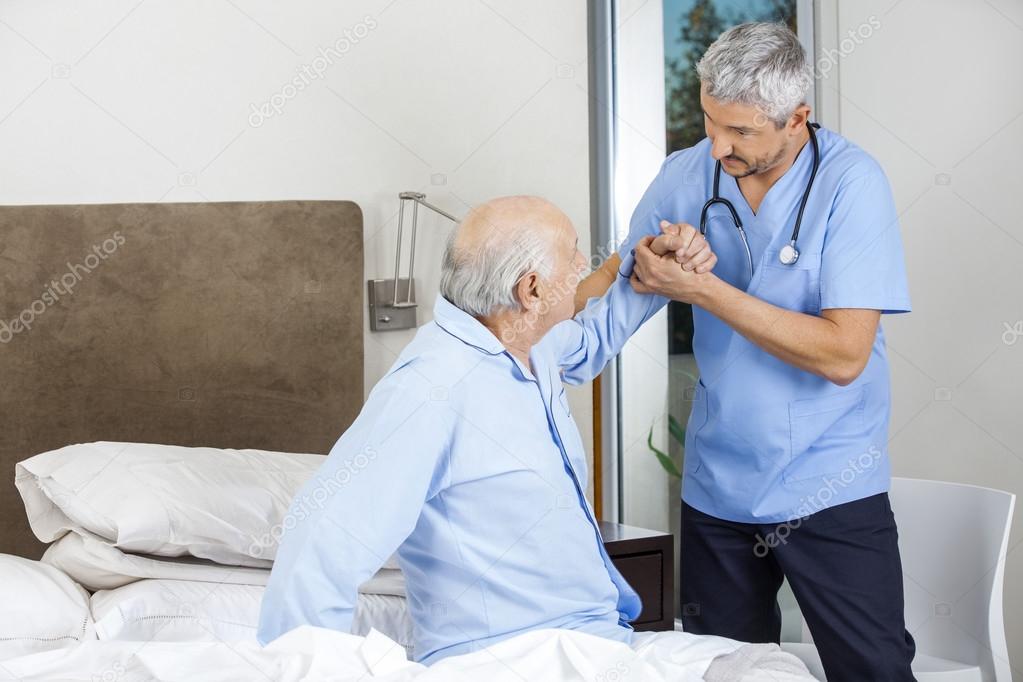 Male Caretaker Assisting Senior Man