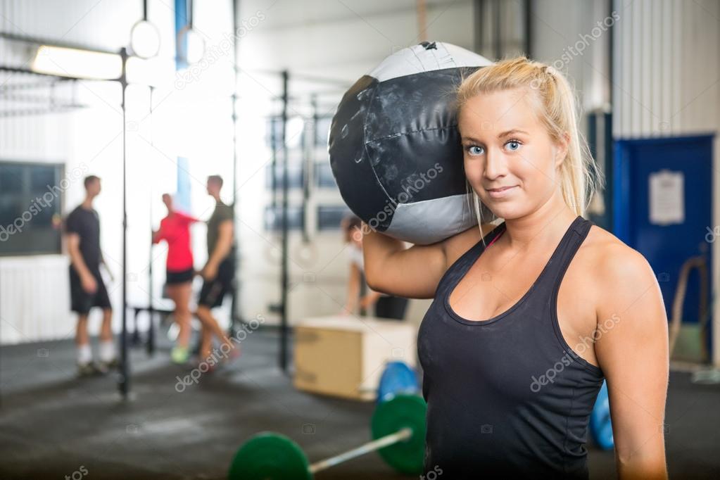 Woman Carrying Medicine Ball At Crossfit Gym