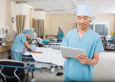 Nurse Using Digital Tablet In Ward clipart