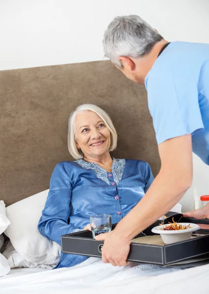 Caretaker Serving Breakfast To Happy Senior Woman — Stock Photo, Image
