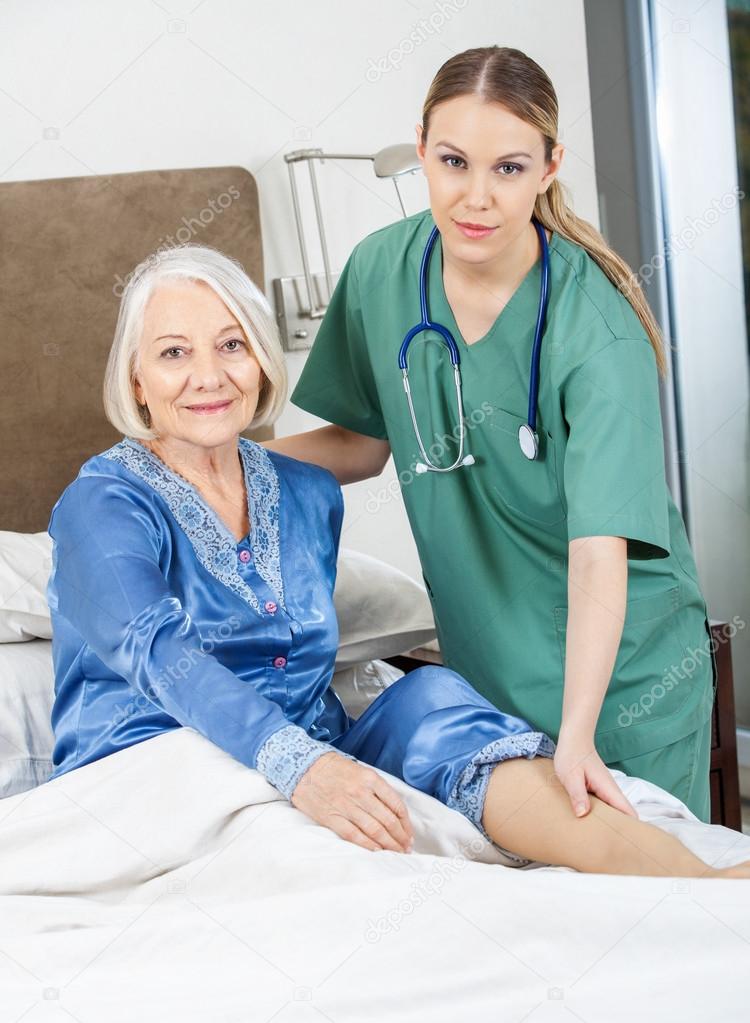 Female Caretaker Checking Senior Womans Leg