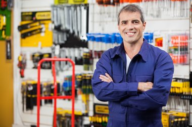 Worker With Arms Crossed In Hardware Shop clipart