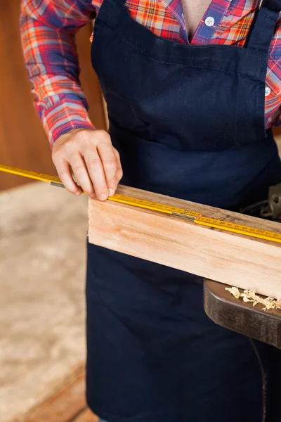 Midsection Of Carpenter Measuring Wood — Stock Photo, Image