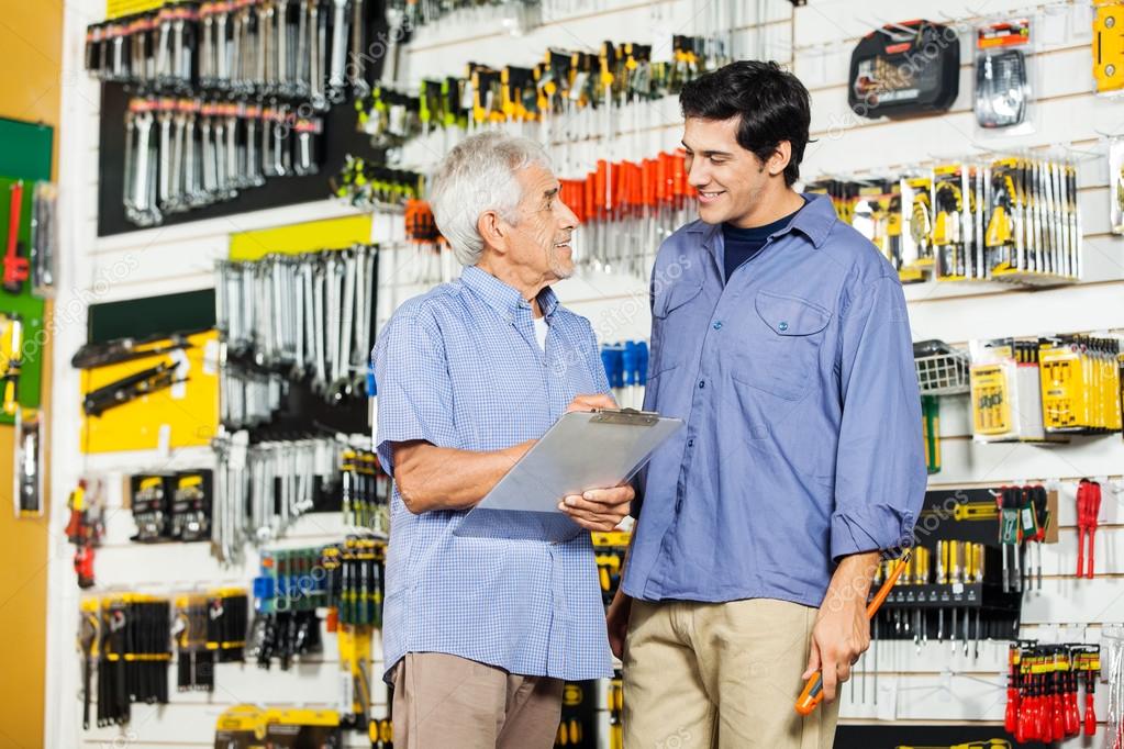 Father With Son Checking List In Hardware Store