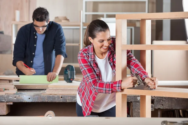 Carpenter Shaving Wood With Planer In Workshop — Stock Photo, Image