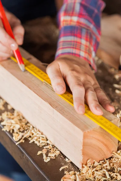 Carpenters Hand Marking On Wood In Workshop — Stock Photo, Image