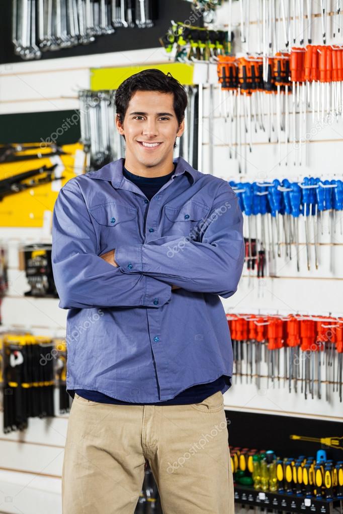 Man Standing Arms Crossed In Hardware Shop