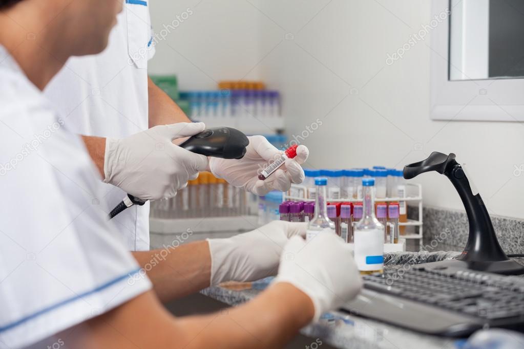 Technicians Scanning Specimens With Barcode Reader ⬇ Stock Photo, Image
