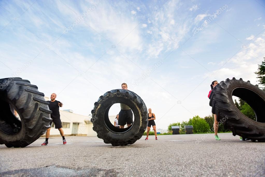 Athletes Doing Tire-Flip Exercise