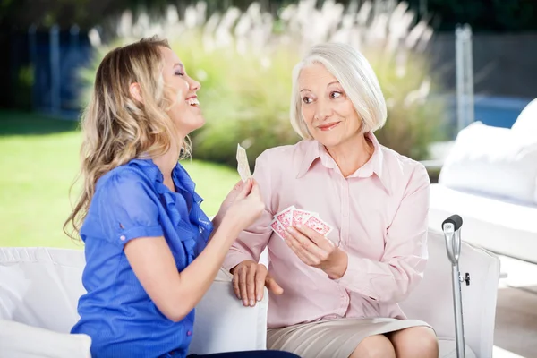 Cheerful Granddaughter Showing Playing Cards To Grandmother — Stock Photo, Image