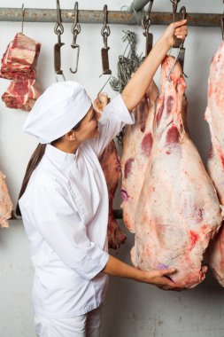 Butcher Hanging Meat In Butchery clipart