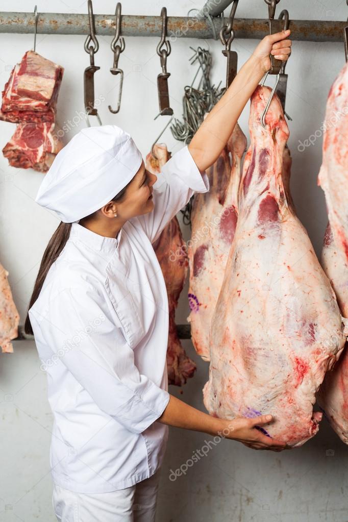 Butcher Hanging Meat In Butchery