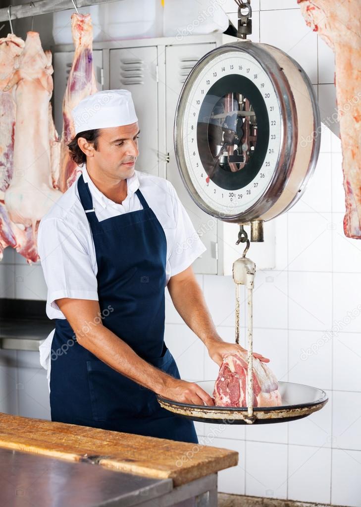 Butcher Weighing Meat On Scale
