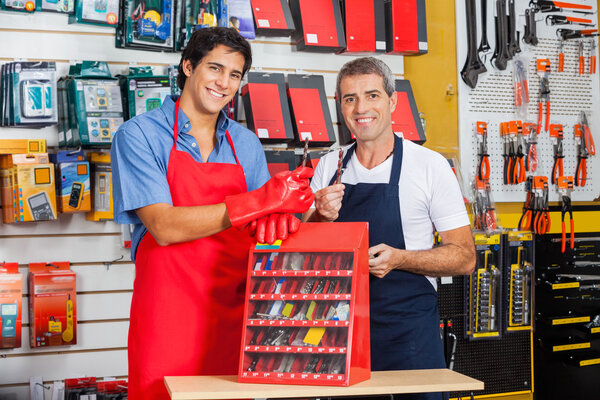 Salesmen Showing Drill Bits In Shop