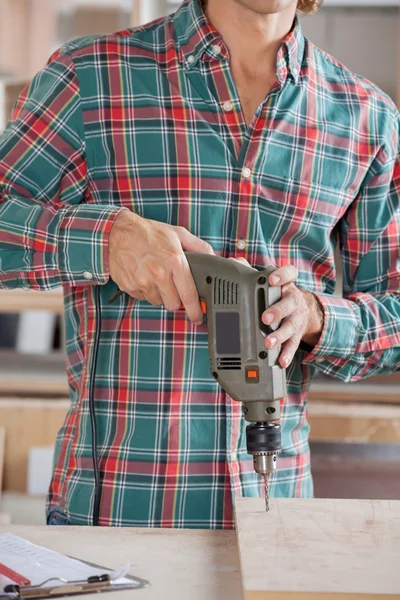 Midsection Of Male Carpenter Drilling Wood — Stock Photo, Image